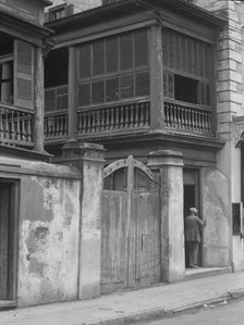 Multi-story house behind gated wall, New Orleans or Charleston, South Carolina, c1920-1926. Creator: Arnold Genthe.