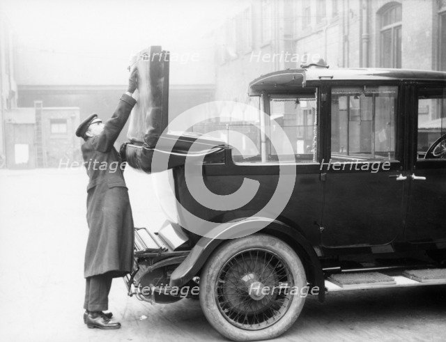 Chauffeur with a partly convertible Daimler. Artist: Unknown