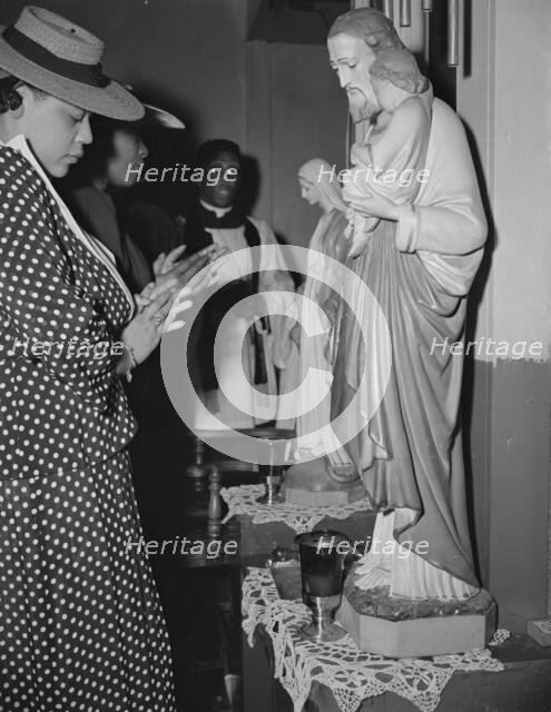 Worshipper before the altar of the St. Martin's Spiritual Church, Washington, D.C., 1942. Creator: Gordon Parks.