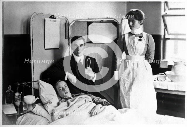 Charing Cross Hospital: Basil Hood with patient, 1904. Creator: Unknown.