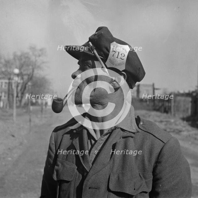 Mr. Venus Alsobrook official salvage collector for the government, Washington, D.C., 1942. Creator: Gordon Parks.