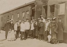 Railway employees against the background of train cars, 1910-1919. Creator: Unknown.