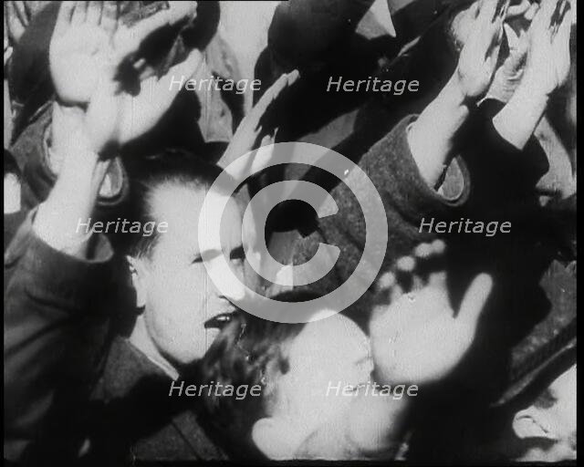 A Close up of Austrian Civilians Performing the German Nazi Salute, 1938. Creator: British Pathe Ltd.