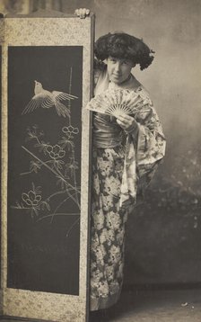 A man wearing a kimono posing from behind a screen, 1906. Creator: Unknown.