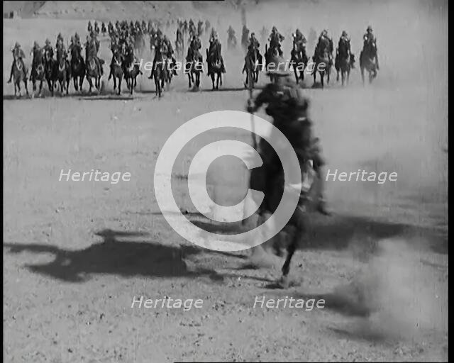 Scene from a Film: Actors Playing British Troops on Horseback Speeding Across a Desert..., 1920s. Creator: British Pathe Ltd.