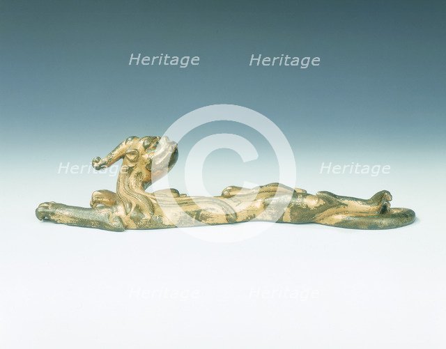 Gilt bronze one-horned kui dragon applique, Ming dynasty, China, c16th century. Artist: Unknown