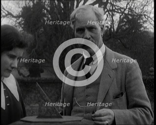 Ramsay MacDonald and His Daughter Ishbel Allan MacDonald Standing Beside a Sundial in a Garden,1920s Creator: British Pathe Ltd.