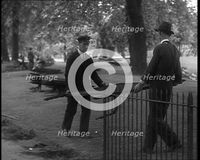 Men Removing Park Railings for Use in Factories, 1940. Creator: British Pathe Ltd.