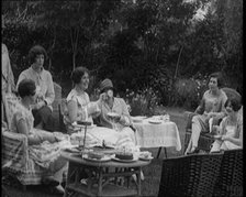 A Group of Female Civilians Drinking Tea and Eating Cakes in the Garden, 1926. Creator: British Pathe Ltd.