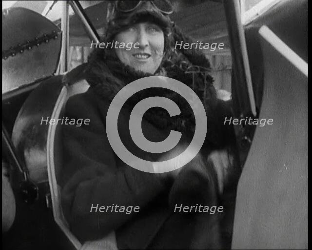 Female Civilian Wearing an Aviator's Hat Onboard of an Airplane, 1927. Creator: British Pathe Ltd.