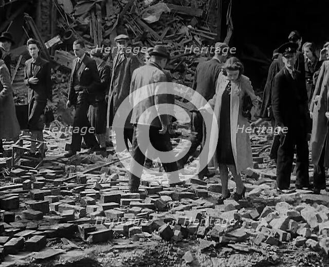 Crowds Walking Past Bombed Out Buildings, 1940. Creator: British Pathe Ltd.