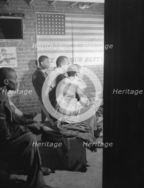 Possibly: Air raid wardens' meeting in zone nine, Southwest area, Washington, D.C., 1942. Creator: Gordon Parks.