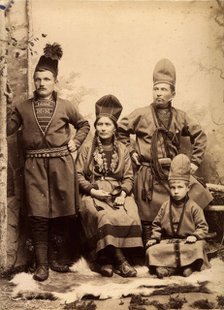 Group picture with four people wearing Sami folk costumes, 1912.  Creator: Helene Edlund.