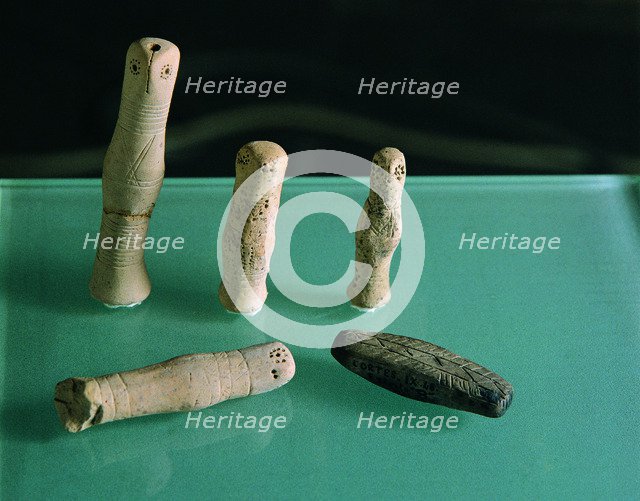Clay figurines, with incised geometric decoration, cylindrical, head of bird (Cortes de Navarra).