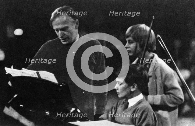 American musician Yehudi Menuhin (1916-1999) instructing his son Jeremy. Artist: Unknown