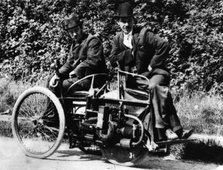 Herbert Austin (left) on 1897 Wolseley Tricar. Creator: Unknown.