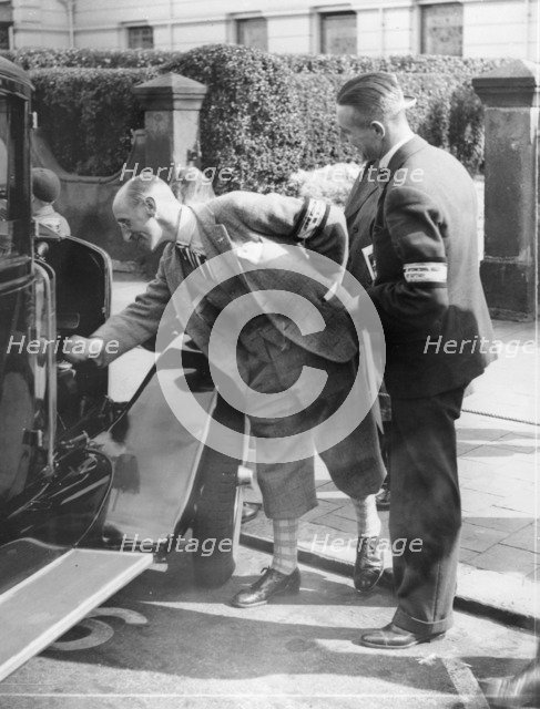 A judge inspecting a car at the Southport Rally, 1928. Artist: Unknown