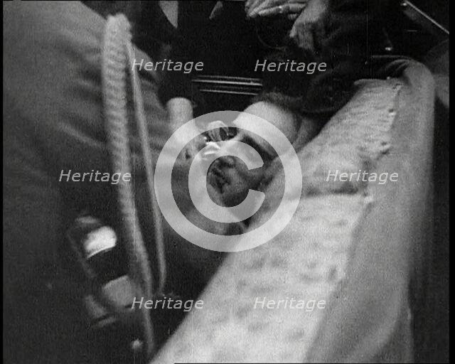 People Inspecting a Corpse, 1934. Creator: British Pathe Ltd.