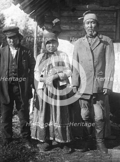 Two Tungus men and a woman with a cross on her chest, 1920-1939. Creator: Unknown.