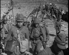 Male Japanese Soldiers With Rifles Walking up a Hillside, Near the City of Hankow, 1937.  Creator: British Pathe Ltd.