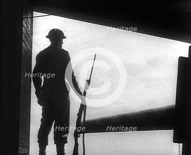 A British Soldier Guarding a Gun Emplacement, 1940. Creator: British Pathe Ltd.
