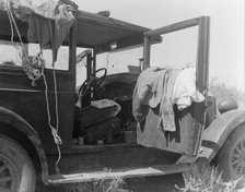 The only home of a depression-routed family of nine from Iowa, 1936. Creator: Dorothea Lange.