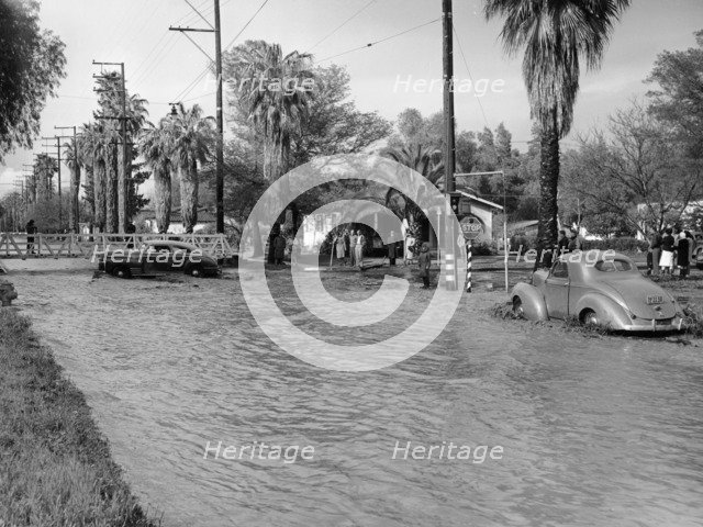 A Pontiac and a Willy's in a flood, USA, c1941. Artist: Unknown
