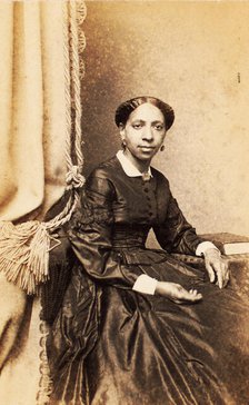 Portrait of woman seated next to tasselled curtain, (1860-1880?). Creator: Abraham Bogardus.