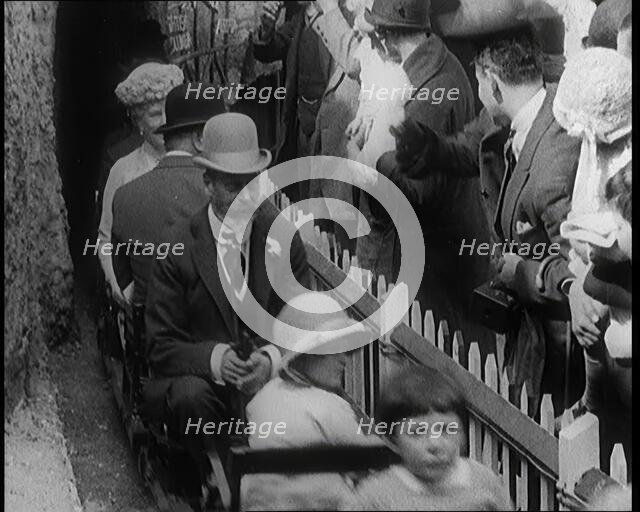 King George V and Queen Mary of the United Kingdom Sit in a Model Train As It Passes..., 1924. Creator: British Pathe Ltd.