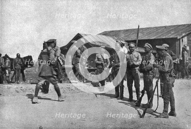 'Ramenés au Devoir; Deserteurs repentis barrant une route pour arreter a leur tour de..., 1917. Creator: Unknown.
