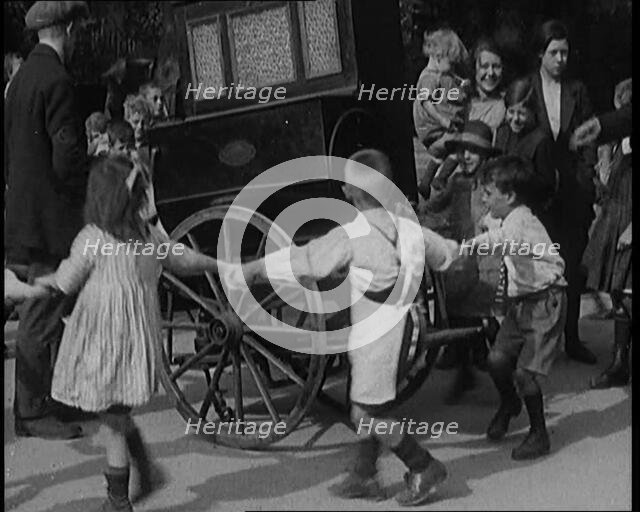 A Group of Civilian Children Dancing Around a Hurdy Gurdy, 1920. Creator: British Pathe Ltd.