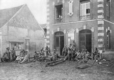German troops sitting on the steps of the Vareddes Town Hall, France, 1914. Artist: Unknown