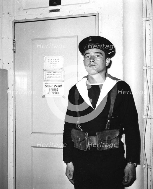 A French sentry outside the operations room of the aircraft carrier 'La Fayette', 1951. Artist: Unknown