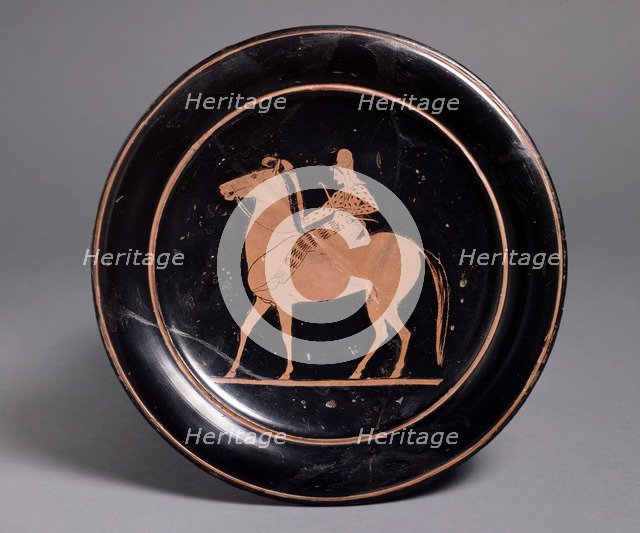 Attic red-figure plate showing a mounted archer in oriental costume in the interior, inscribeld Mil Artists: Unknown, Paseas.