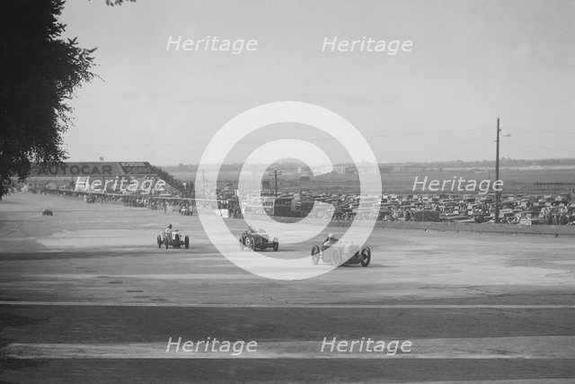 'Rubber Duck', Austin 7 of LP Driscoll, leading two MG Cs, BRDC 500 Mile Race, Brooklands, 1931. Artist: Bill Brunell.