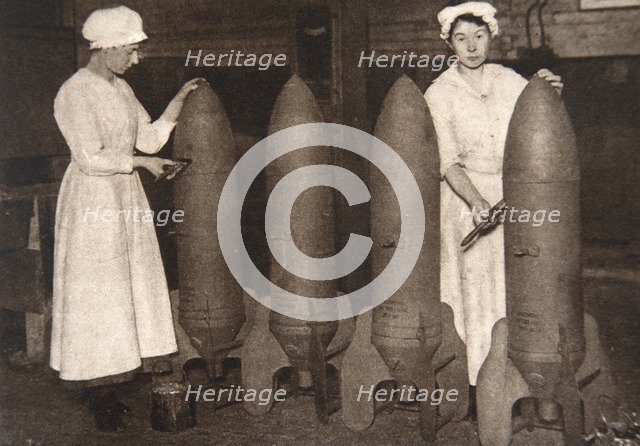 Women munitions workers putting a coat of paint on aerial bombs, World War I, c1914-c1918. Artist: S and G