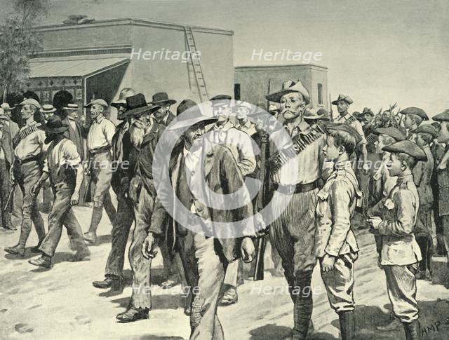 'The Last Attack on Mafeking: B.S.A. Police Escorting Boer Prisoners to the Gaol', 1901. Creator: Henry Marriott Paget.