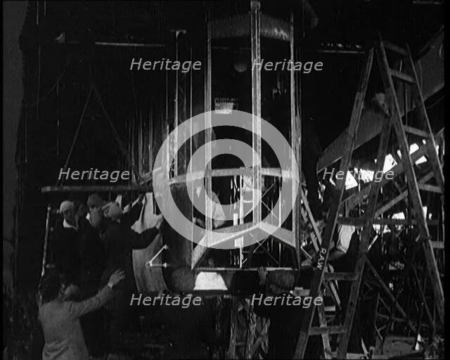 Men and Women Building the Body of the Cockpit of an R 38 Airship in a Hangar, 1921. Creator: British Pathe Ltd.