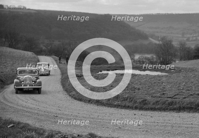 Rover of BN Wilmott and Jaguar SS of Dr AR Gray competing in the RAC Rally, 1939. Artist: Bill Brunell.