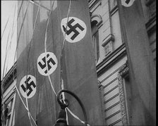 German Nazi Banner Flags Hanging from the Frontage of a Building, 1939. Creator: British Pathe Ltd.