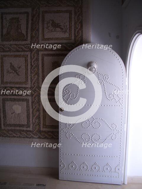 Studded door and mosaic, El Jem Museum, El Djem, Tunisia, 2009. Creator: Amanda Waite.