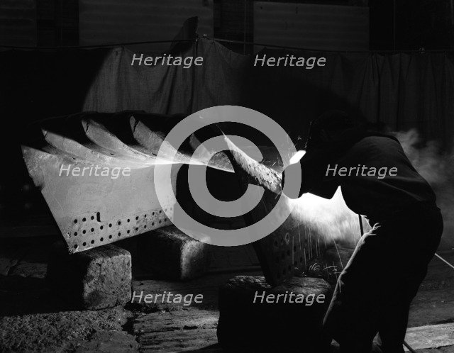 Welding a dragline bucket, Edgar Allen Steel Co, Sheffield, South Yorkshire, 1962. Artist: Michael Walters