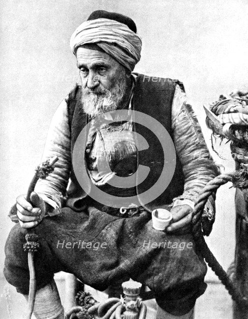 A peasant drinking coffee and smoking a huqqah, Izmir, Turkey, 1936. Artist: Unknown