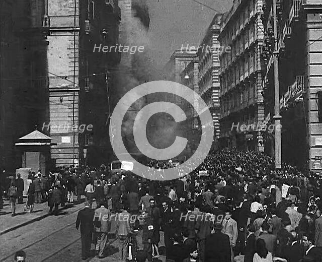 Italian Civilians Moving Slowly Through Bomb-Damaged Naples, 1943-1944. Creator: British Pathe Ltd.