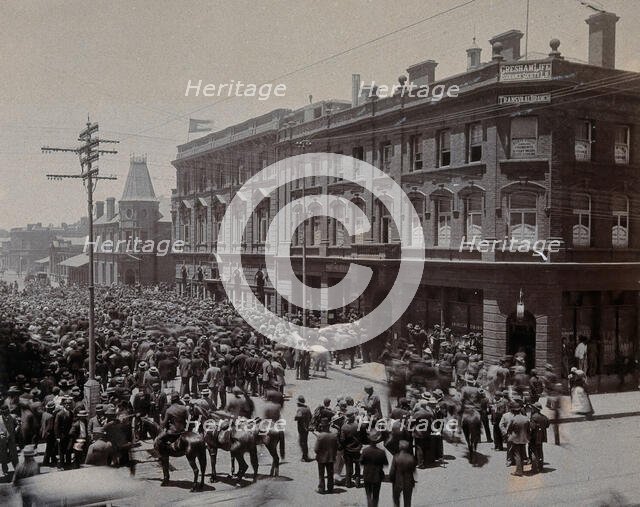 South Africa: a crowd of people gathered outside The Goldfields offices in Johannesburg, 1896. Creator: Unknown.