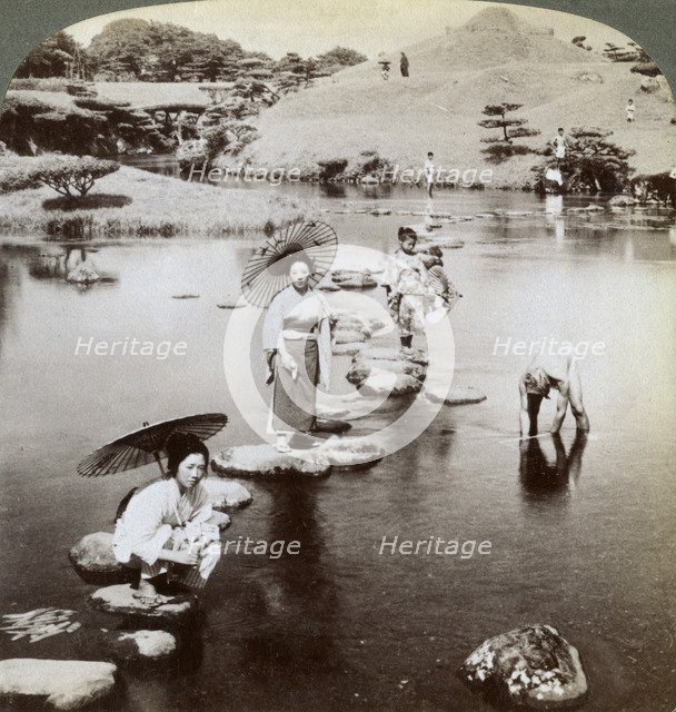 Women crossing the lake on stepping stones, Suizen-ji Garden, Kumamoto, Japan, 1904.Artist: Underwood & Underwood