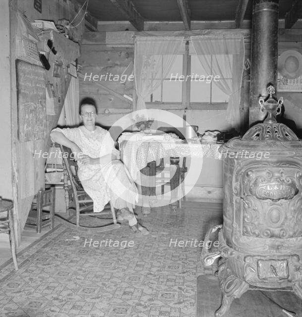 Mrs. Hull and corner of her one-room basement dugout, Dead Ox Flat, Malheur County, Oregon, 1939. Creator: Dorothea Lange.