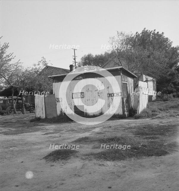 Privy in cheap migratory camp, San Joaquin Valley, California, 1936. Creator: Dorothea Lange.