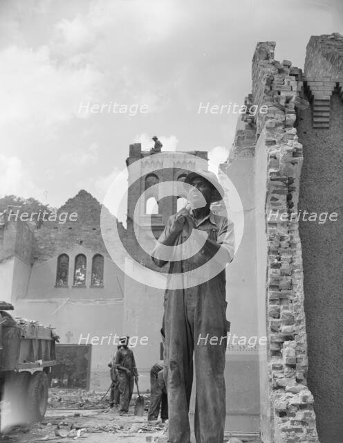 Construction workman wrecking a church on Independence Avenue, Washington, D.C, 1942. Creator: Gordon Parks.