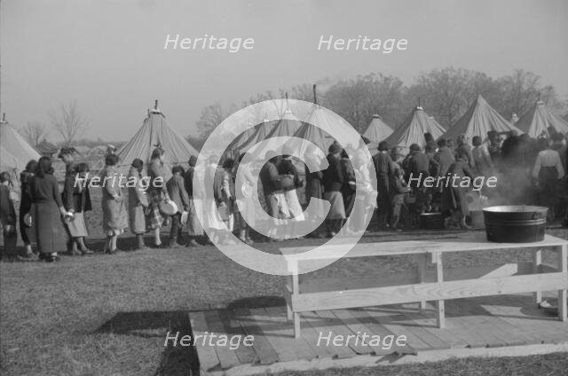Possibly: Refugees lined up at meal time in the camp for white flood...Forest City, Arkansas, 1937. Creator: Walker Evans.